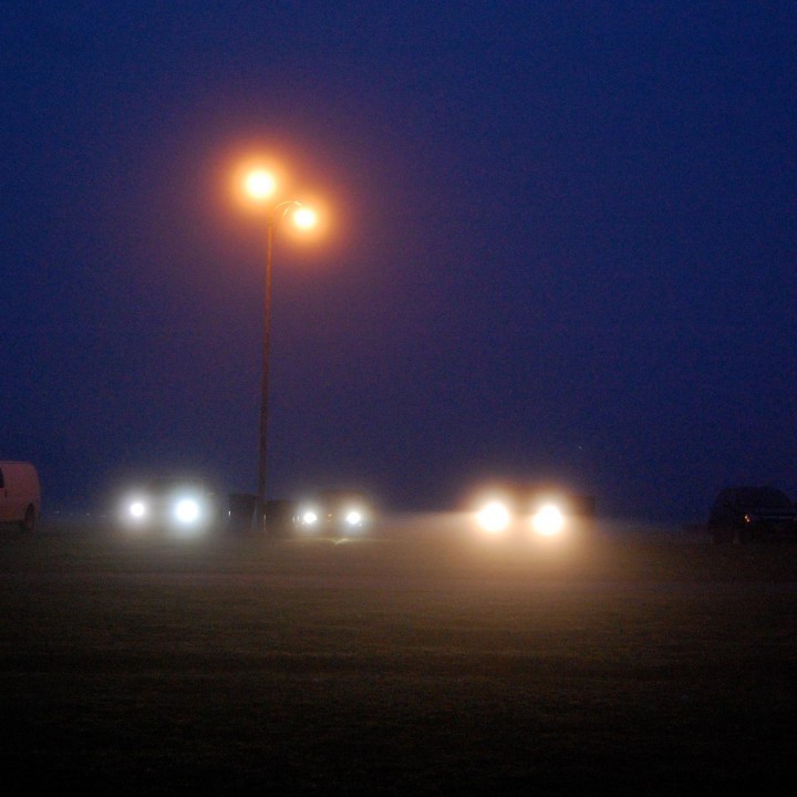 Headlights in the dark mist
