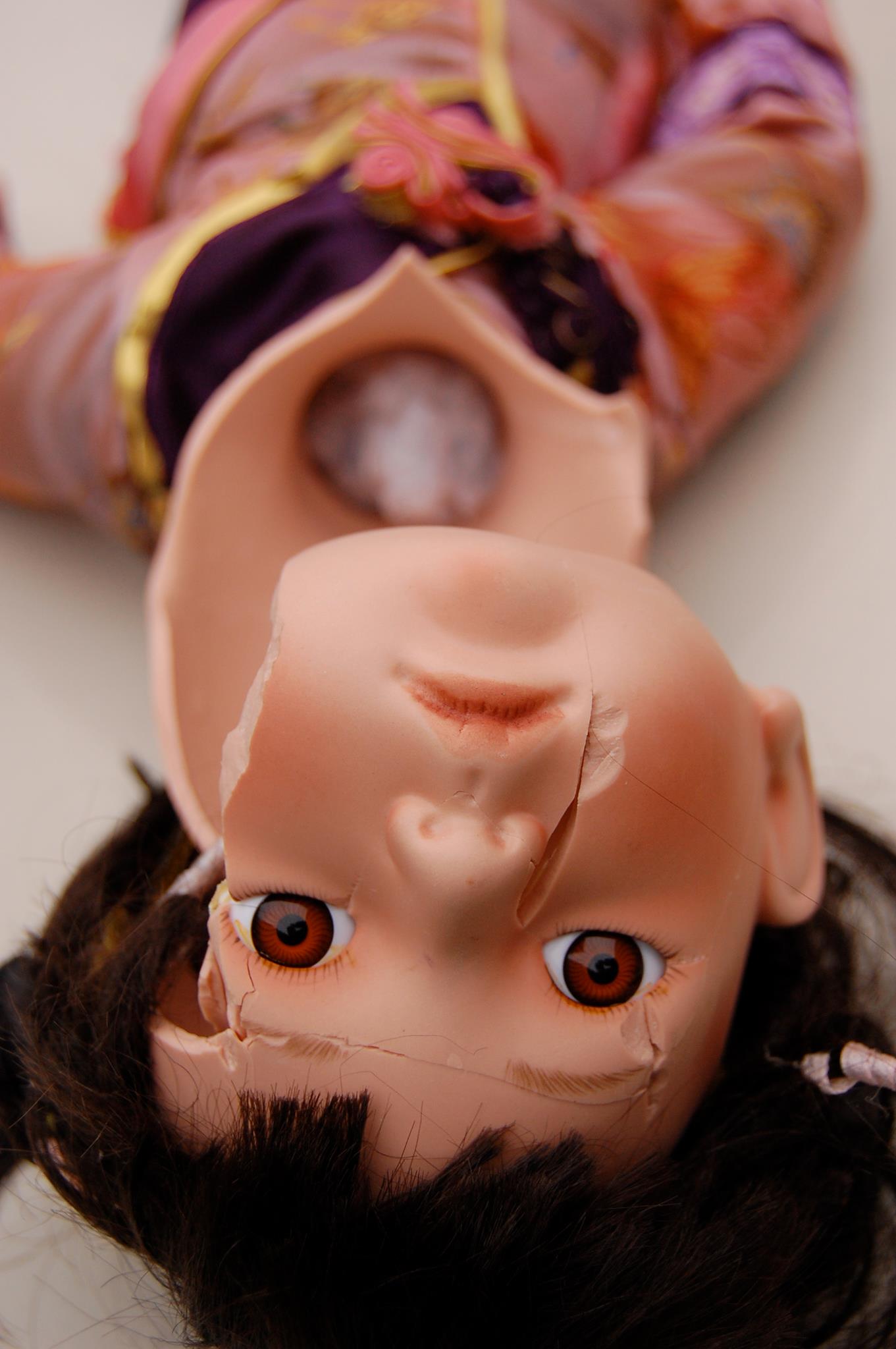 Broken ceramic doll upside down