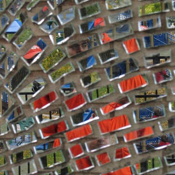 Reflection of a face in a mosaic of mirror fragments