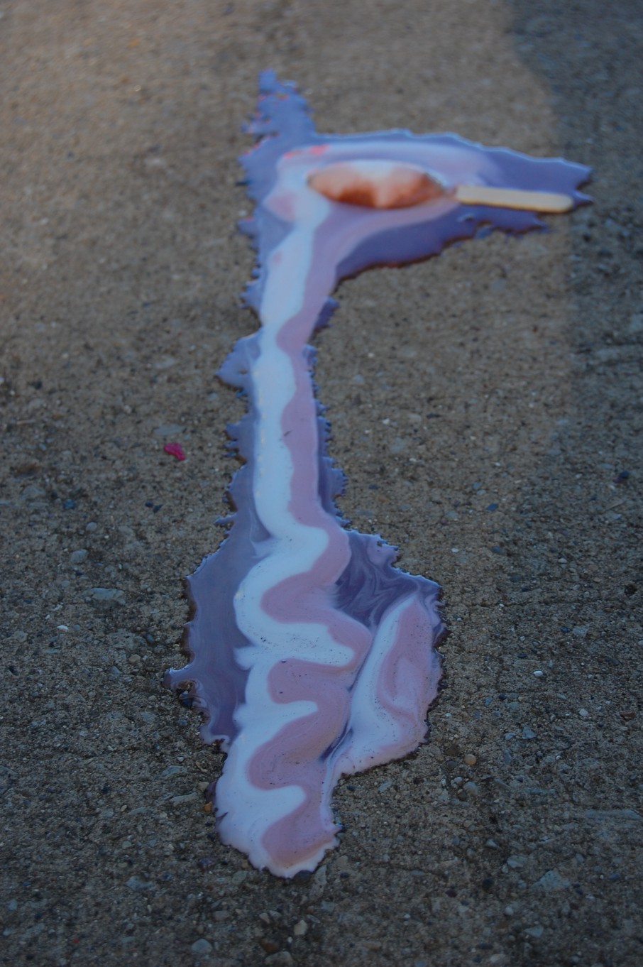 Ice cream melting on pavement