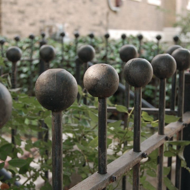 Black Iron fence top balls in receding zig-zag pattern
