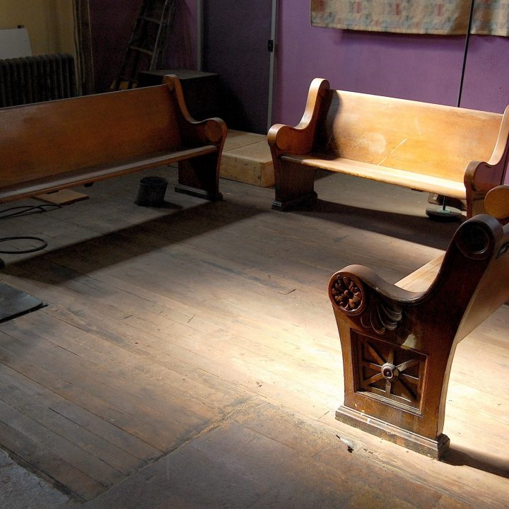 Church pews in gallery splashed in sunlight