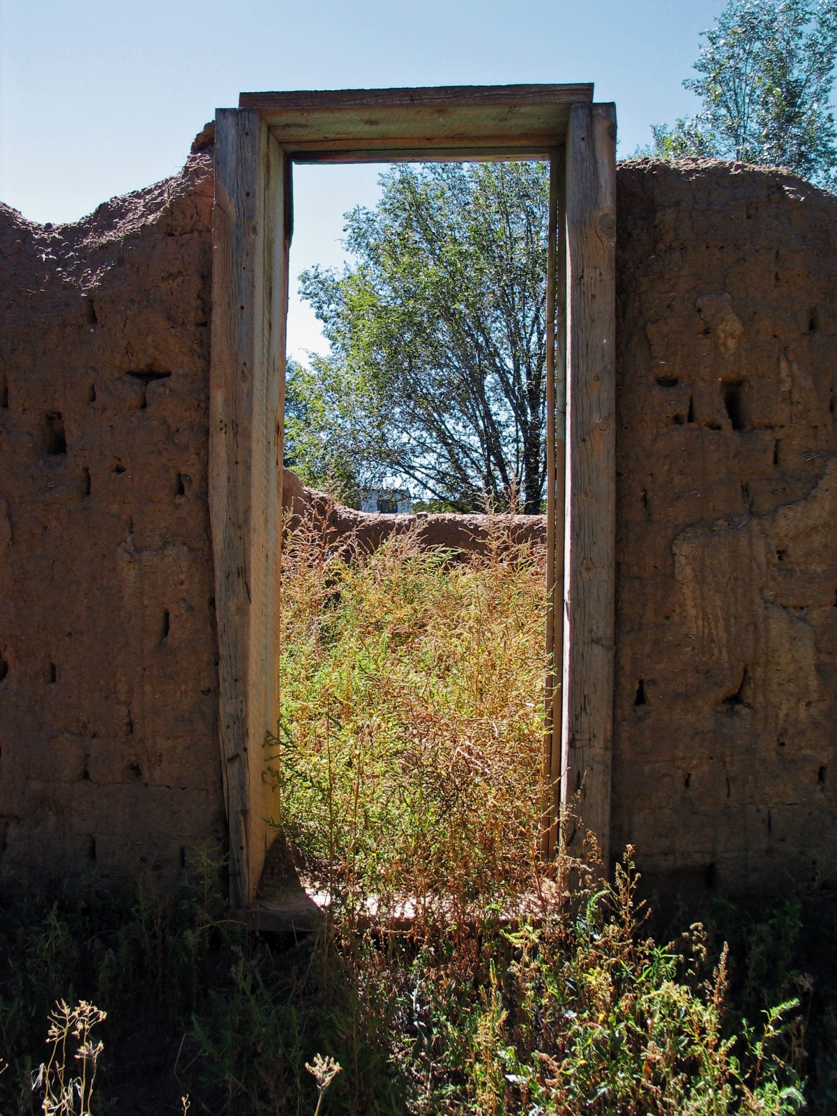 Unfinished adobe construction doorway new mexico