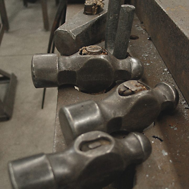 Ball peen and metalworking hammers in a steel work top